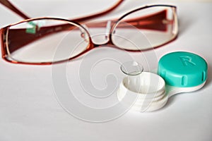 Contact lenses and glasses on a white background. The topic of medicine and health care. Up close