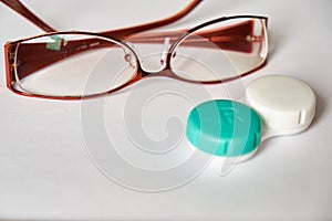 Contact lenses and glasses on a white background. The topic of medicine and health care. Up close