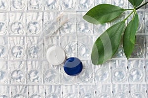 Contact lenses, tweezers and lens storage container. Close up. Selective focus