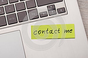 Contact me sticky note on laptop