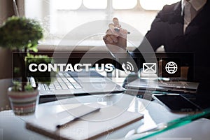 Contact us button and text on virtual screen. Business and technology concept.