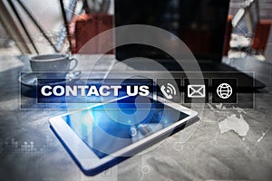 Contact us button and text on virtual screen. Business and technology concept.