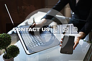 Contact us button and text on virtual screen. Business and technology concept.