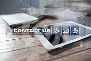 Contact us button and text on virtual screen. Business and technology concept.