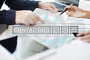 Contact us button and text on virtual screen. Business and technology concept.