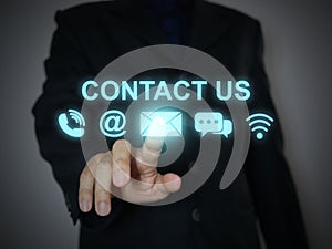 Contact us or Customer support concept. Businessman tapping on a virtual screen of contact icons:  phone, address, email, live