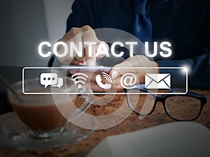 CONTACT US, Hand of Businessman using his smartphone with related contact icons: live chat, internet wifi, phone, address, and