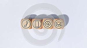 Contact us icons on wooden blocks isolated