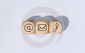 Contact us icons on wooden blocks isolated