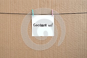 Contact us! Note is written on a white sticker that hangs with a