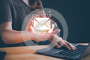 Contact us symbol icon in woman hand. Customer support hotline people connect. Businesswoman using a laptop computer and touching