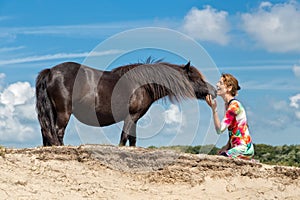 Contact woman and black pony