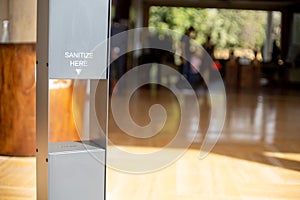 contactfree automated mist sanitizer pillar at the entrance gate of a hotel pub bar, restaurant public space with out of