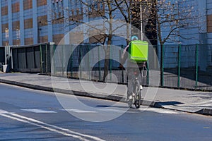 Contactless delivery of food, food and things by Bicycle around the city during the coronavirus pandemic. The courier is driving