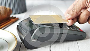 contactless payment concept with young man paying with credit card