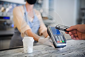 Contactless payment with debit card, coffee shop open after lockdown.