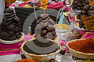 Container with almond mole powder in a street market photo