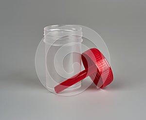 Container for biomaterial with spoon