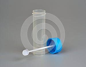 Container for biomaterial with spoon