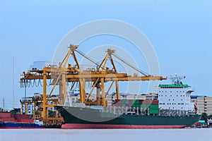 Container Cargo freight ship with working crane br