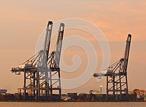 Container Cargo freight ship with working crane bridge in shipyard