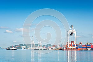 Container Cargo freight ship with working crane bridge in shipyard at dusk for Logistic Import Export