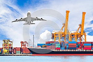 Container cargo freight ship with working crane loading bridge