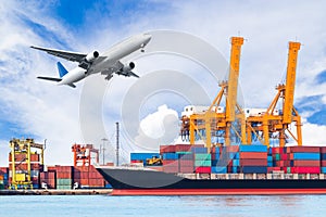 Container cargo freight ship with working crane loading bridge