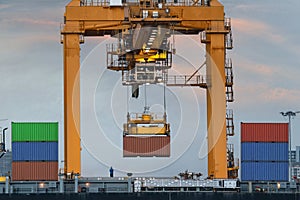 Container Cargo freight ship with working crane loading bridge i