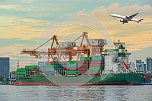 Container Cargo freight ship with working crane loading bridge i