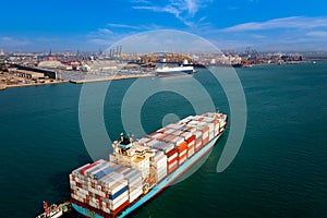 Container cargo ship carrying commercial container in import export business commerce logistic and transportation of