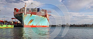 Container cargo ship load in the seaport. Logistics and transportation of Container Cargo ship with working crane bridge in