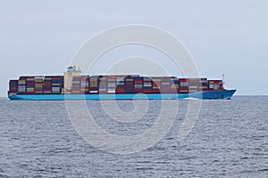 Container cargo ship underway in the ocean.