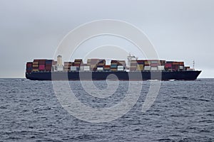 Container cargo ship underway in the ocean.