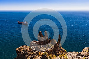 Container cargo ship and vessel on horizon