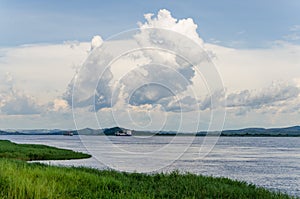 Container cargo ships on mighty Congo river with dramatic sky photo