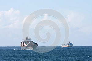 Container cargo ships passing at sea