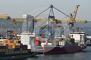 Container carriers alongside unloading containers in Belfast Harbour, UK