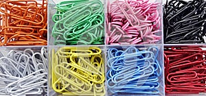 Container Of Coloured Paperclips.