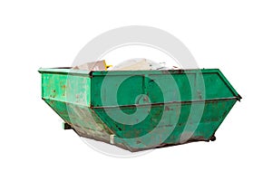 Container for construction waste with broken bricks on the background of a multi-storey building