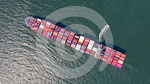 Container , container ship in export and import business and logistics. Shipping cargo to harbor by crane. Water transport