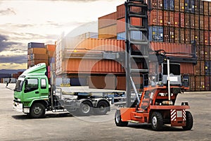 Container Crane Tractor Lifting up Container Box on Trailer Truck. Cargo Container ships, Freight Trucks Import-Export.