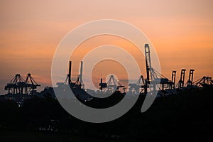 Container cranes at Singapore Cargo Terminals at sunset