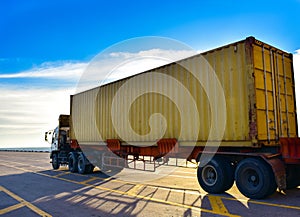 Truck carries forty feet container with clear sky background. photo