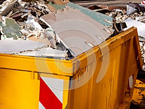 Container with drywall rubble construction site