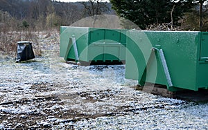 Container of green color for garden waste. it is weighed for bio composting or for thermal use as wood chips. The street and lawn