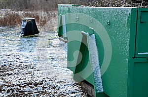 Container of green color for garden waste. it is weighed for bio composting or for thermal use as wood chips. The street and lawn