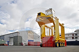 Container handler in the port. Lifting the shipping container.