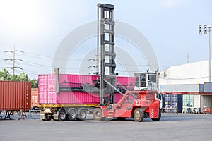 Container handlers are loading containers into trucks