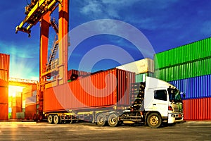 Container handling. Container truck picking up container at yard. Port logistics, container yard operation